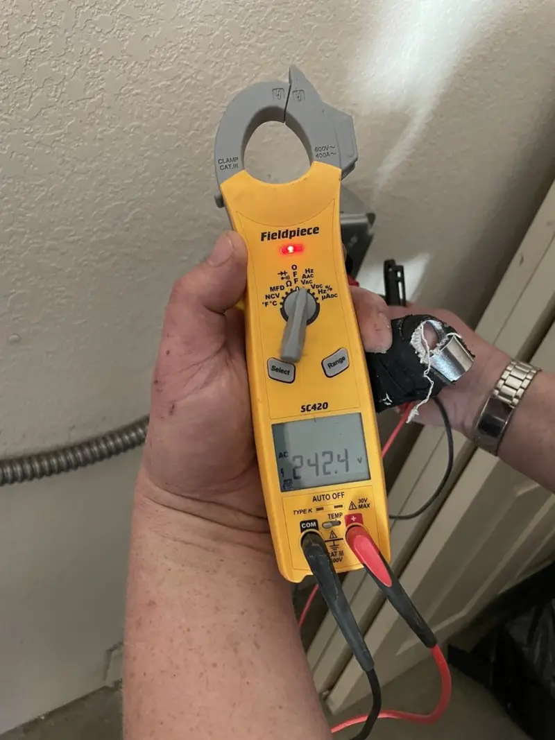 Voltage testing with clamp meter during Whole House Surge Protector in Cherokee Village